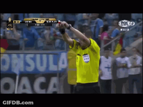Man In Yellow FIFA Shirt In Front Of DACA Sign GIF
