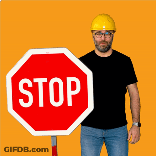 Man In Yellow Hard Hat Holding Stop Sign GIF