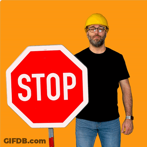 Man In Yellow Hard Hat Holding Stop Sign GIF