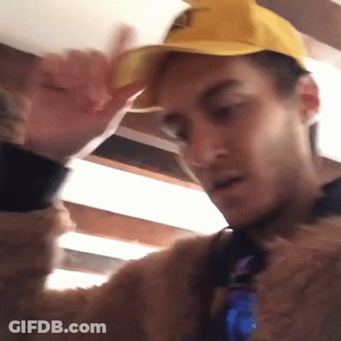 Man In Yellow Hat And Fur Coat GIF