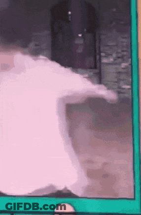 Man In Yellow Hat And Headphones Walking Down Hallway GIF