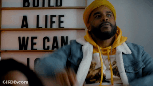 Man In Yellow Hat With Sign Build A Life We Can GIF