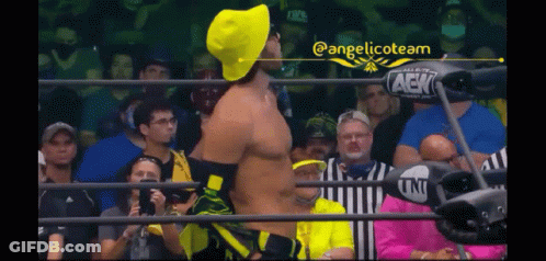 Man In Yellow Hat Wrestling Ring With Fans GIF