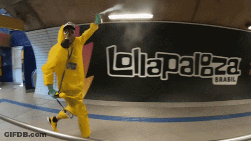 Man In Yellow Hazmat Suit Sprays In Front Of Lollapaloza Brasil Sign GIF