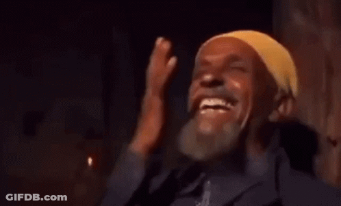 Man In Yellow Headband Laughing Covering Face GIF