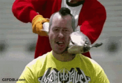 Man In Yellow Heavy Metal Shirt Being Shaved By Santa GIF