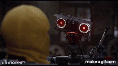 Man In Yellow Hood Watching Robot With Red Lights GIF