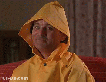 Man In Yellow Hooded Raincoat Smiling GIF