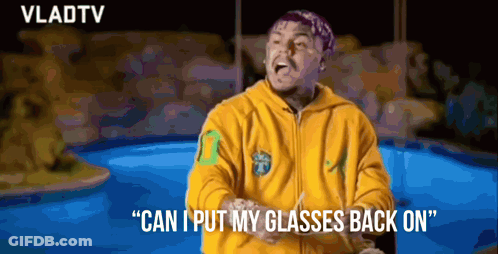 Man In Yellow Hoodie Putting On Glasses GIF