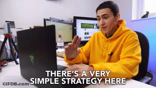 Man In Yellow Hoodie Sitting At Desk With Laptop Saying There's A Very Simple Strategy GIF