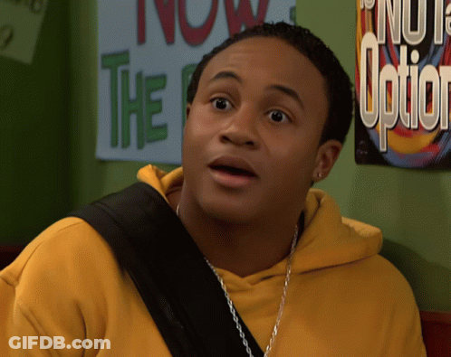 Man In Yellow Hoodie Standing In Front Of Sign Saying Now The Option GIF