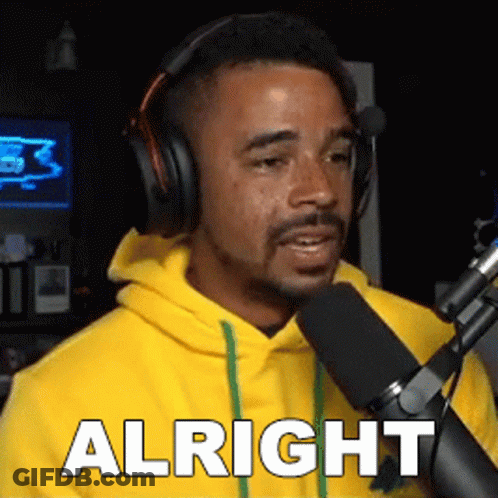 Man In Yellow Hoodie Talking Into Microphone Saying Alright GIF