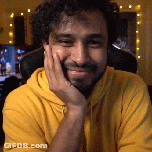 Man In Yellow Hoodie With Hand On Face GIF