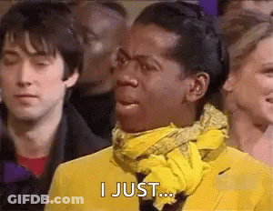 Man In Yellow Jacket And Scarf Making Funny Face In Crowd GIF