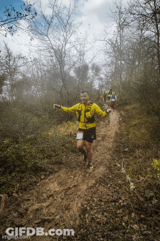 Man In Yellow Jacket And Shorts Running GIF