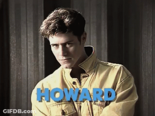 Man In Yellow Jacket By Wall Saying Howard GIF