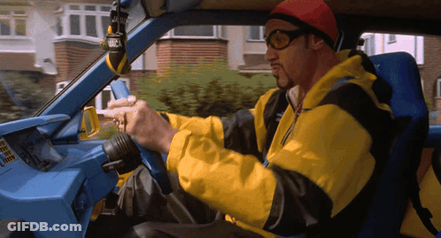 Man In Yellow Jacket Driving Blue Car GIF