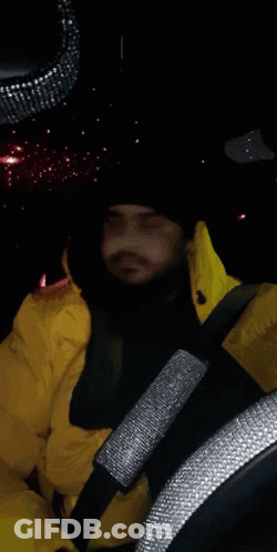 Man In Yellow Jacket Driving Car GIF