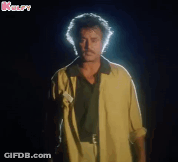Man In Yellow Jacket Eyes Closed In Dark GIF