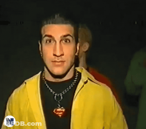 Man In Yellow Jacket Giving Peace Sign GIF