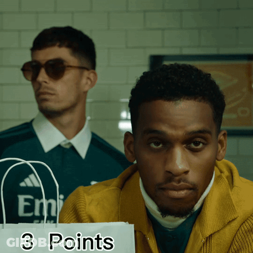 Man In Yellow Jacket Holding 3 Points Bag GIF