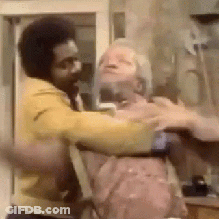 Man In Yellow Jacket Holding Another Man In Yellow Jacket GIF