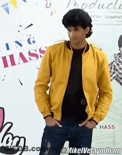 Man In Yellow Jacket In Front Of Hass Sign GIF
