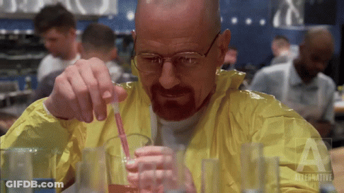 Man In Yellow Jacket Pouring Liquid Into Glass With Straw GIF