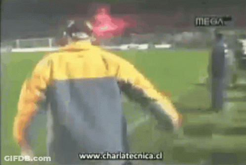 Man In Yellow Jacket Running On Soccer Field With Charlatecnica.cl GIF