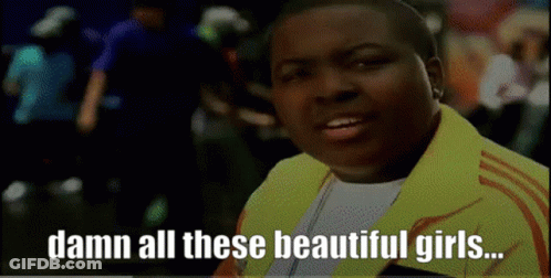 Man In Yellow Jacket Saying Damn All These Beautiful Girls GIF