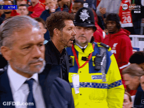 Man In Yellow Jacket Saying Police In Crowd GIF