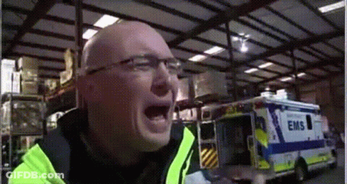 Man In Yellow Jacket Screaming In Front Of EMS Ambulance GIF