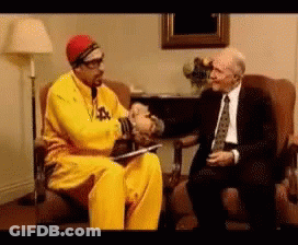Man In Yellow Jacket Shaking Hands GIF