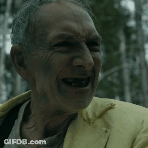 Man In Yellow Jacket Smiling With Mouth Open GIF