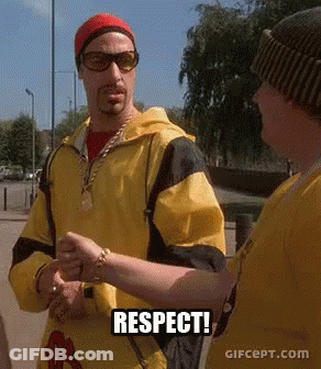 Man In Yellow Jacket Talking To Man In Sunglasses And Red Hat Respect GIF
