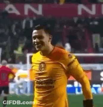 Man In Yellow Jersey Smiling On Soccer Field GIF