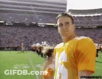 Man In Yellow Jersey Standing On Football Field In Front Of Stadium GIF