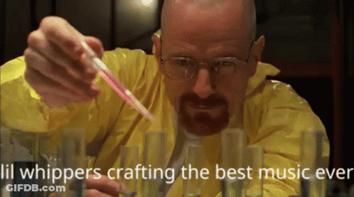 Man In Yellow Lab Coat Pouring Into Test Tubes GIF