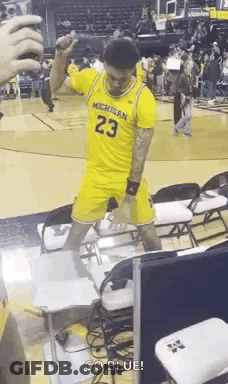 Man In Yellow Michigan Jersey On Basketball Court GIF