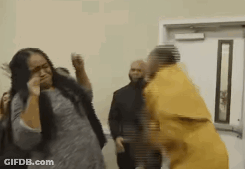 Man In Yellow Prison Uniform Next To Woman In Gray Shirt GIF