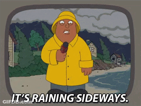 Man In Yellow Raincoat Holding Microphone It's Raining Sideways GIF