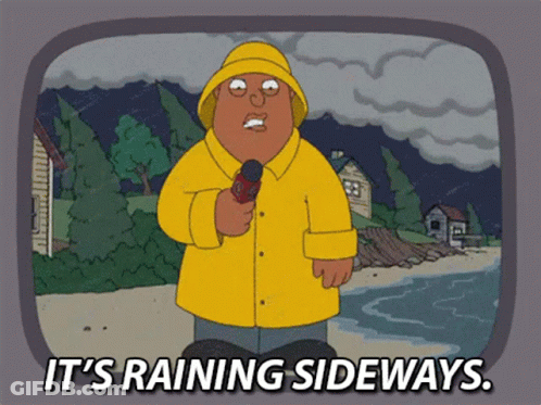 Man In Yellow Raincoat Saying It's Raining Sideways GIF