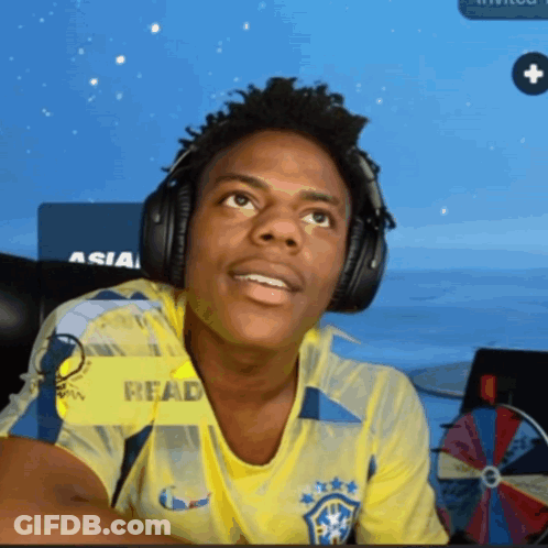 Man In Yellow Read Shirt With Headphones GIF