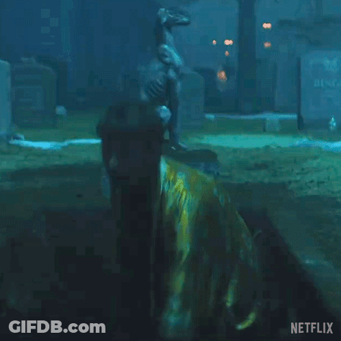 Man In Yellow Robe Holding Pole With Netflix Logo GIF