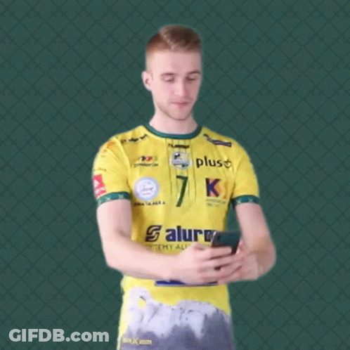 Man In Yellow Saturn Shirt Taking Selfie GIF