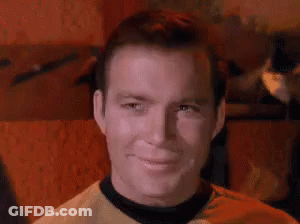 Man In Yellow Shirt And Black Collar Smiling GIF