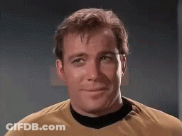 Man In Yellow Shirt And Black Collar Smiling GIF