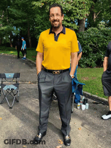 Man In Yellow Shirt And Black Pants In Parking Lot GIF