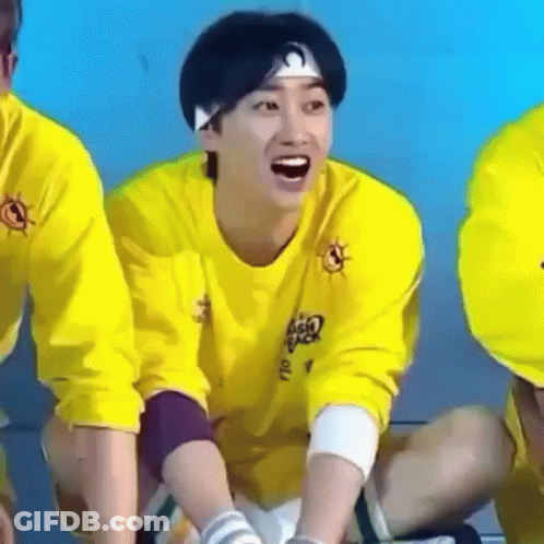 Man In Yellow Shirt And Headband Laughing On Floor GIF