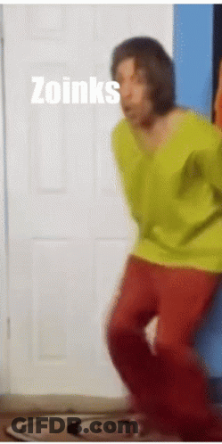 Man In Yellow Shirt And Red Pants Dancing In Front Of Zoinks Door GIF
